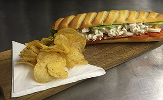 Freshly made sandwich served with crisps